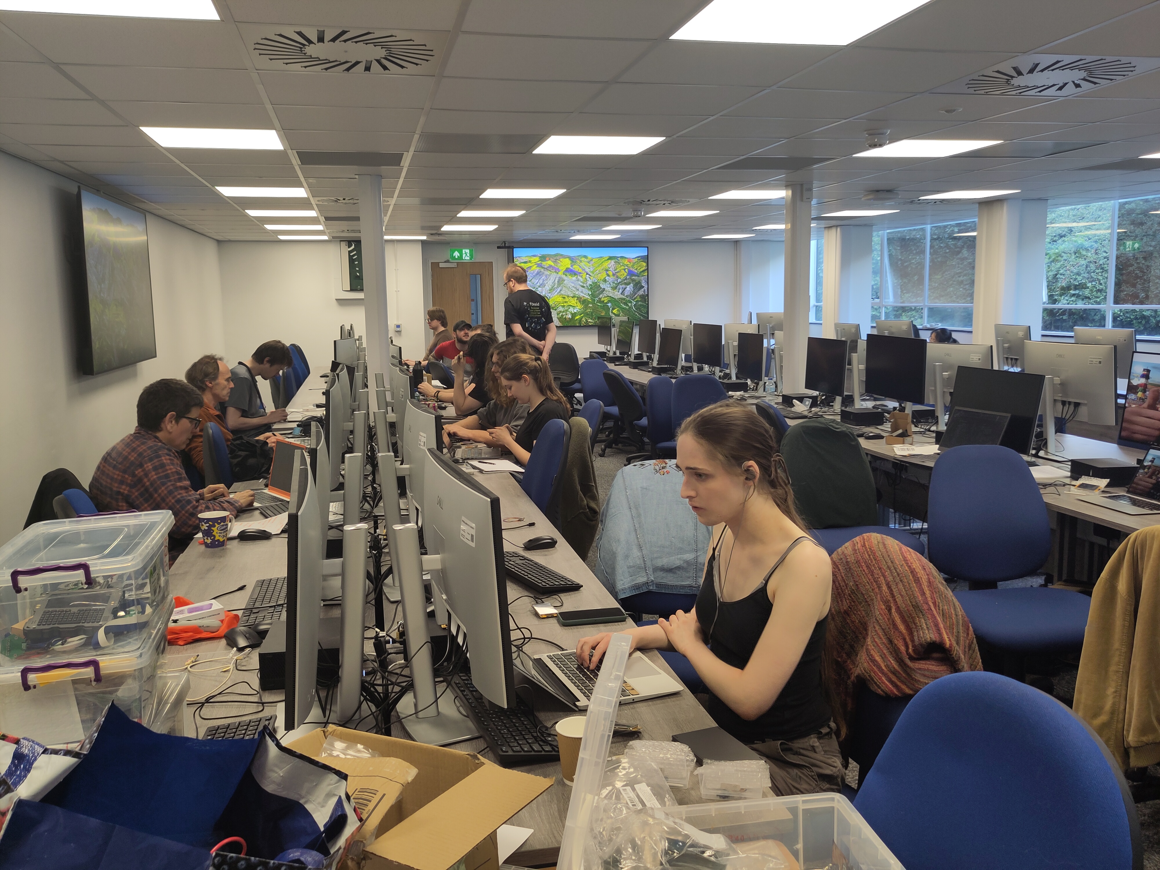 Rosia suffering in a room full of people coding