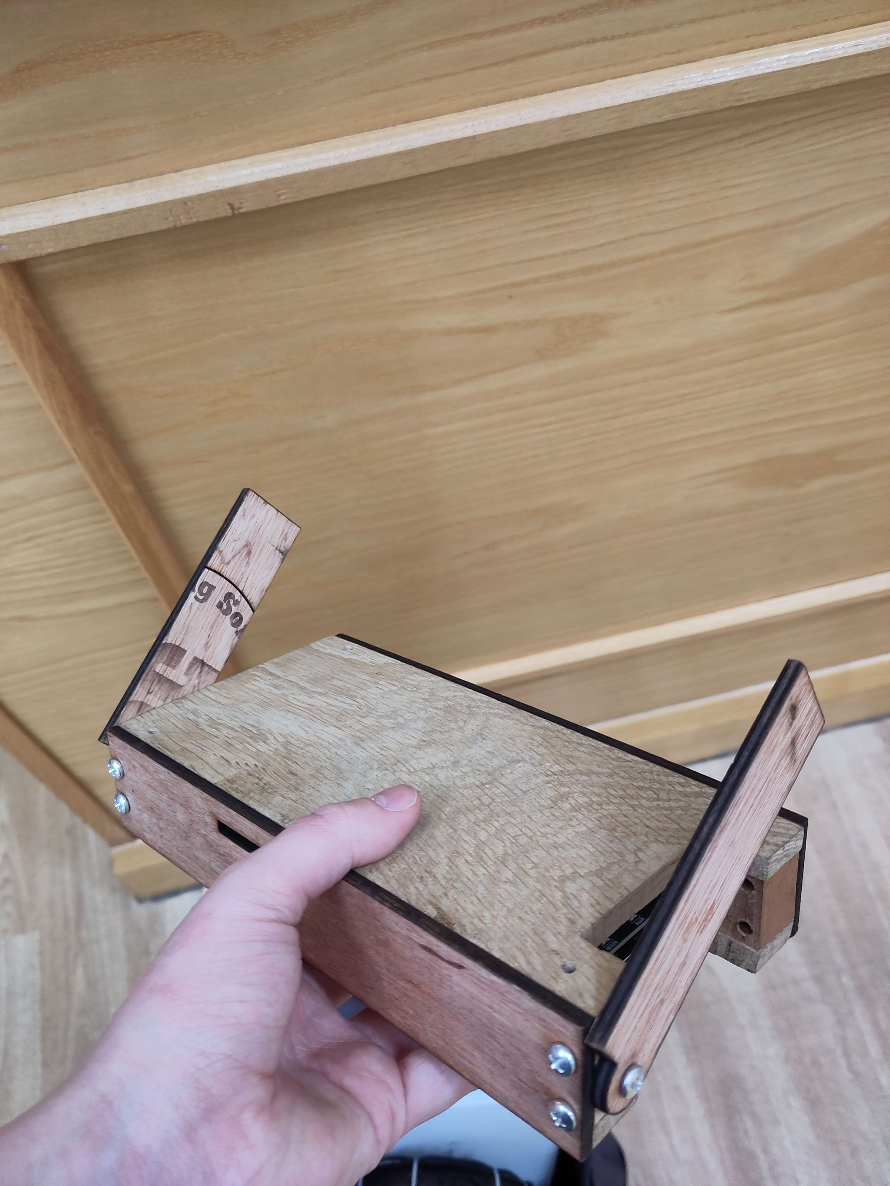 A wooden case for my computer, the length of a forearm and the width of two, it has two wooden flaps on hinges where a screen could be attached